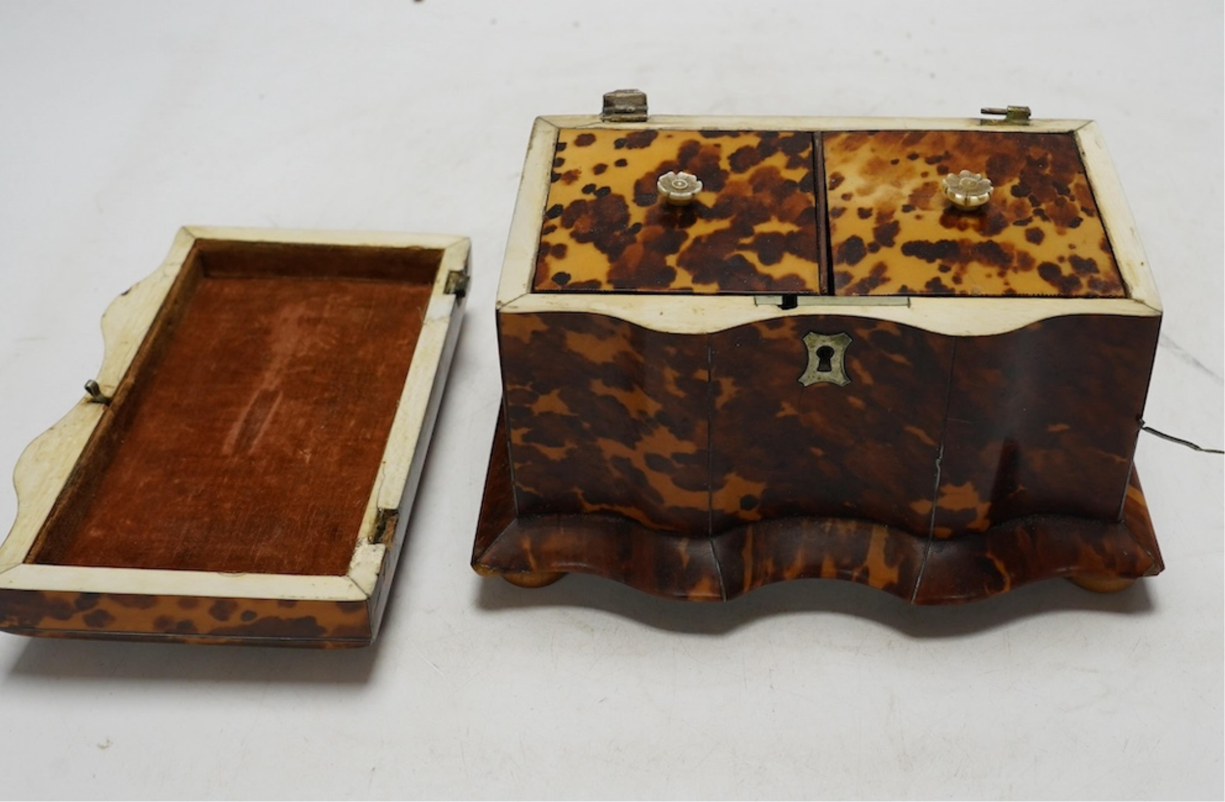 A Regency tortoiseshell tea caddy with inlaid silver and ivory stringing, on later bun feet, 12cm high. CITES Submission reference 64HKMP8J. Condition - poor to fair, lid detached, some repairs needed to stringing